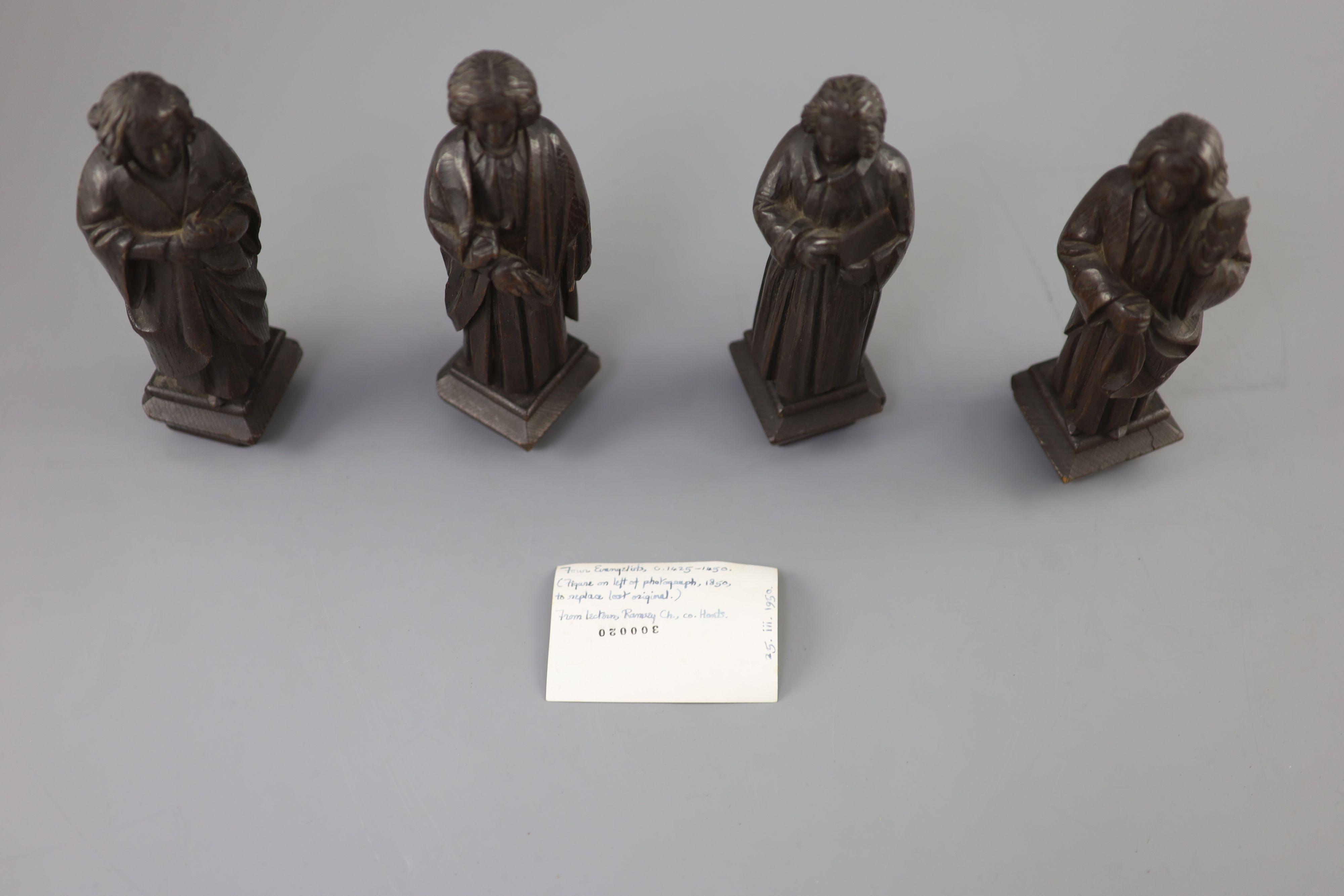 Four English oak figures of Evangelists, three possibly c.1425-50, one a 19th century copy, from Romsey Abbey? 19cm high Provenance - A